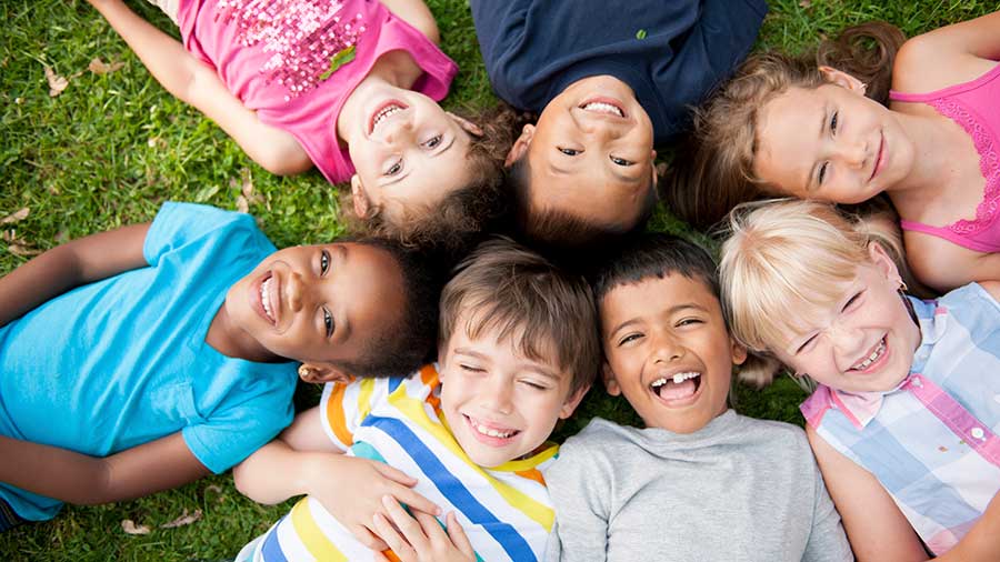 Group of children laying in grass